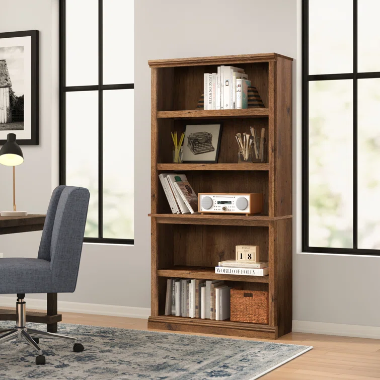 White modern wooden bookcase with five shelves displaying organized book collection
