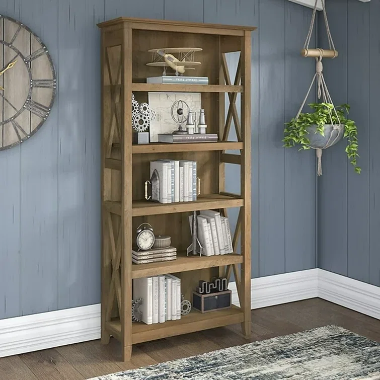 Tall wooden bookcase with upper shelves and lower cabinet storage by large window