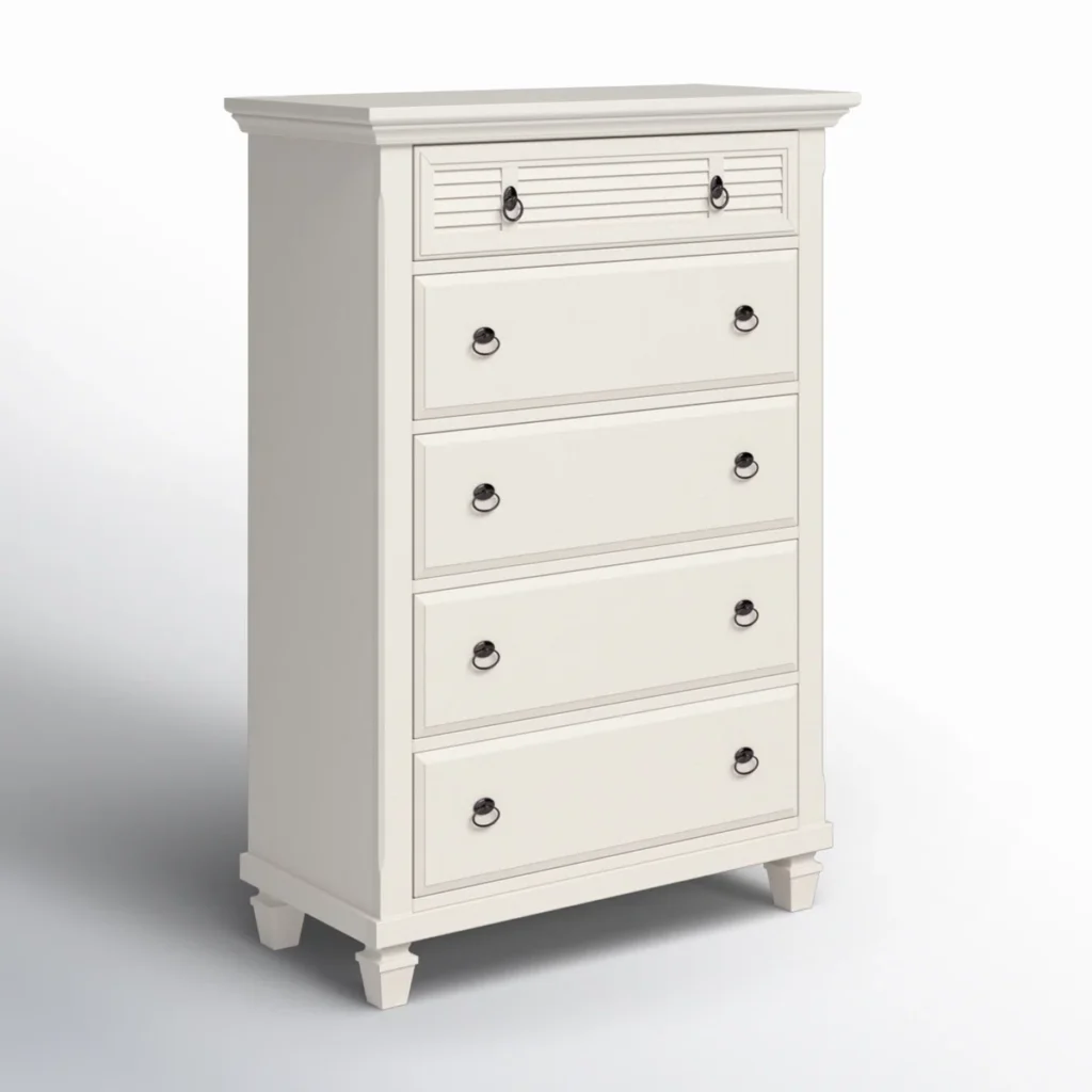 White cottage-style five-drawer tall chest with decorative louvered details and dark round pulls on white background