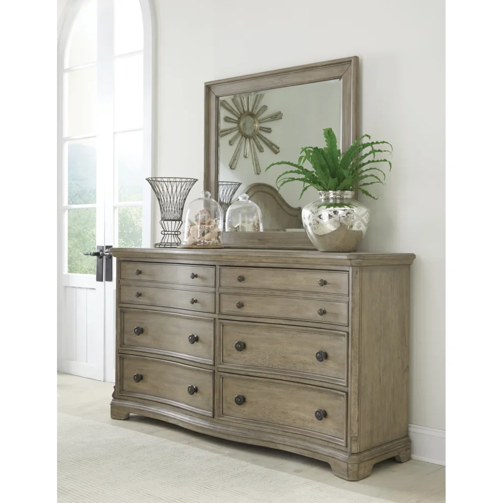 Sophisticated gray-brown eight-drawer double dresser with matching mirror and dark bronze hardware in transitional bedroom setting