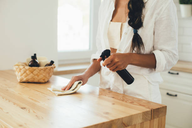 Woman cleaning and preparing quality wood furniture before painting, essential step for repainting furniture
