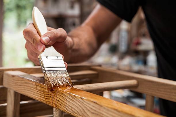 White paint stroke on black background, showing paint texture for wood furniture projects